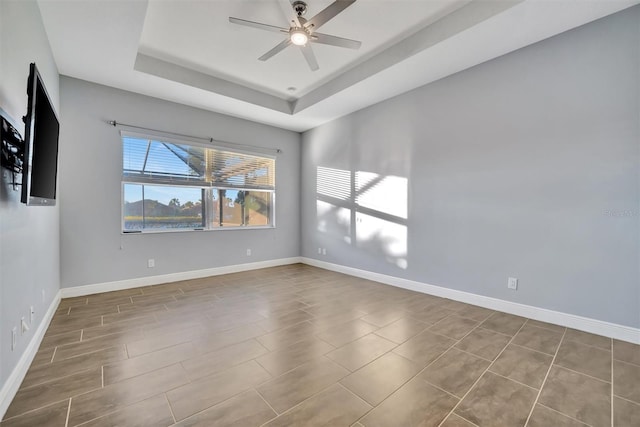 unfurnished room featuring a tray ceiling and ceiling fan