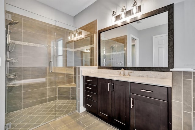 bathroom featuring vanity and an enclosed shower