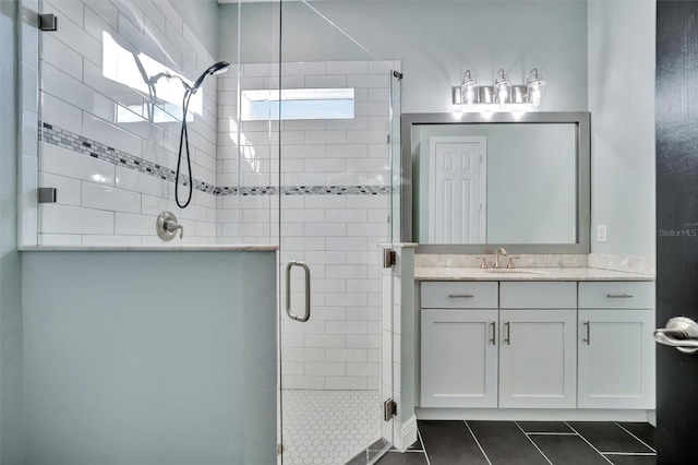 bathroom featuring vanity, tile patterned flooring, and a shower with shower door