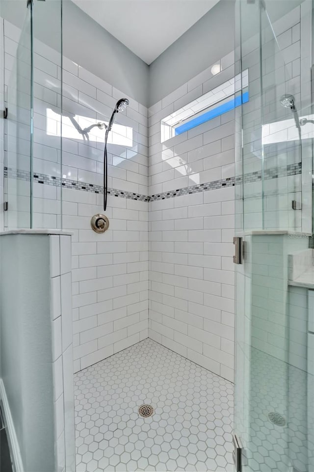 bathroom featuring a shower with shower door