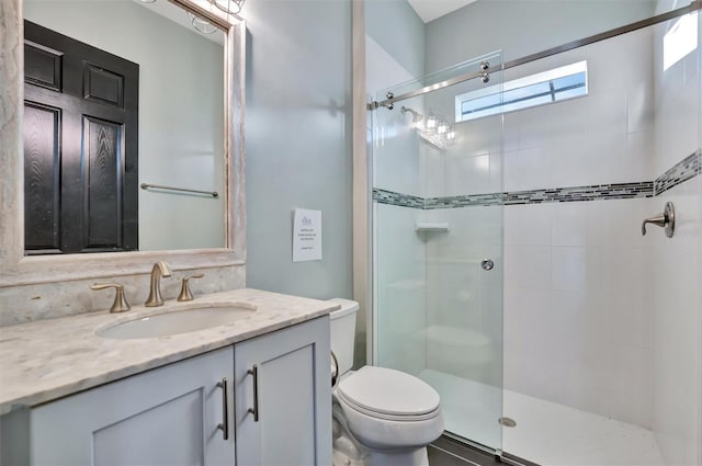 bathroom featuring walk in shower, vanity, and toilet