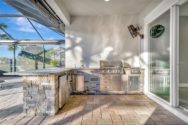 view of patio with area for grilling, grilling area, and sink