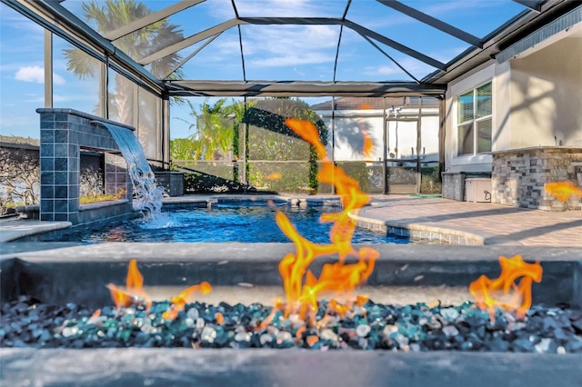 exterior space with an outdoor fire pit and glass enclosure