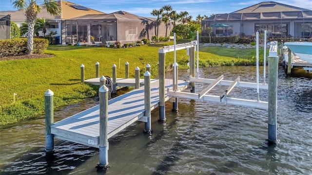 dock area featuring a water view and a yard