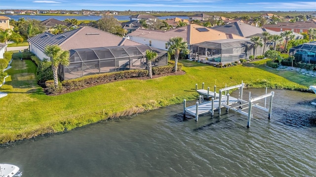 view of dock with a water view, a swimming pool, glass enclosure, and a lawn