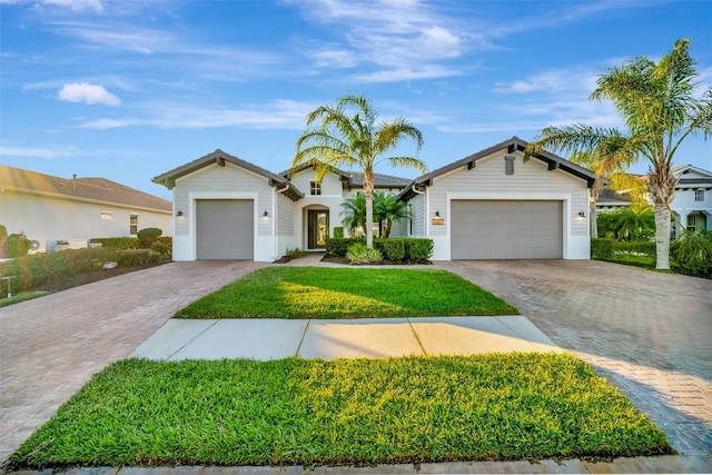 single story home with a garage and a front yard