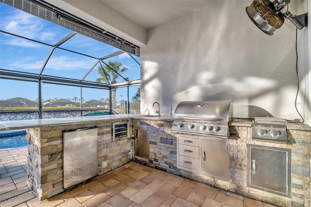 5607 Tidewater Preserve Blvd, Bradenton, FL 34208 - view of patio with an outdoor kitchen, a lanai, and a water view