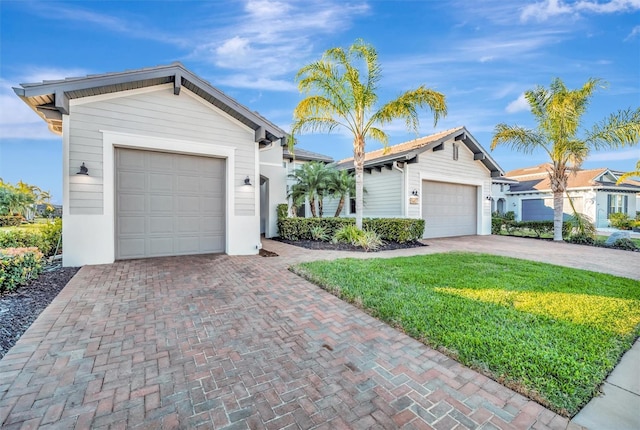 5607 Tidewater Preserve Blvd, Bradenton, FL 34208 - ranch-style home with decorative driveway, a front yard, and a garage