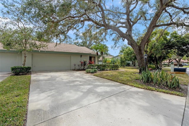 ranch-style home featuring a garage and a front lawn