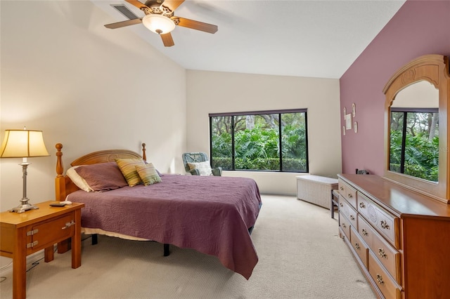 carpeted bedroom featuring lofted ceiling, radiator, multiple windows, and ceiling fan