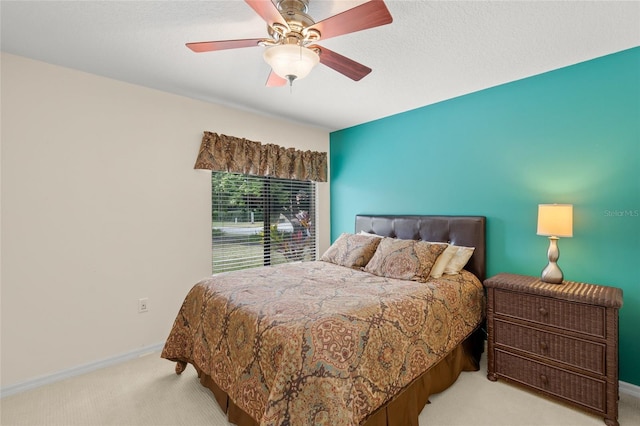 bedroom with ceiling fan and light colored carpet