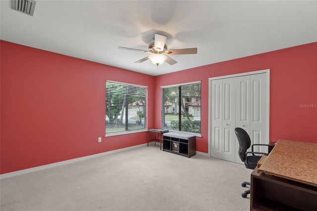 office with ceiling fan, light carpet, and a textured ceiling