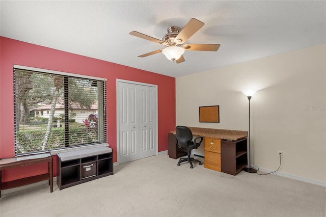 carpeted home office with ceiling fan