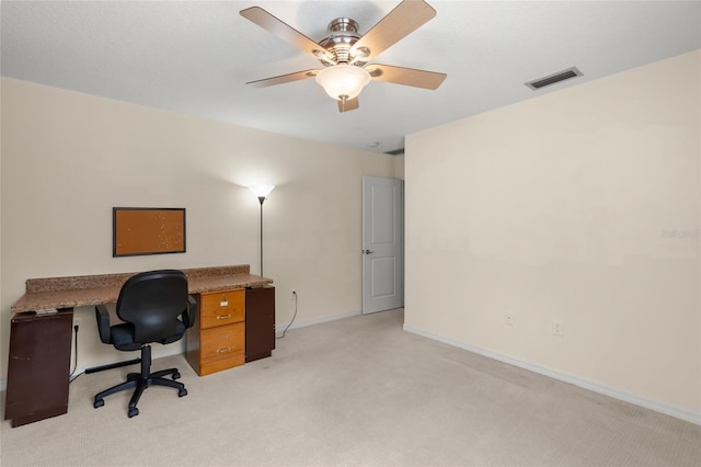 carpeted office space featuring ceiling fan