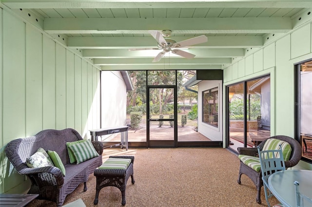 sunroom with ceiling fan and beam ceiling