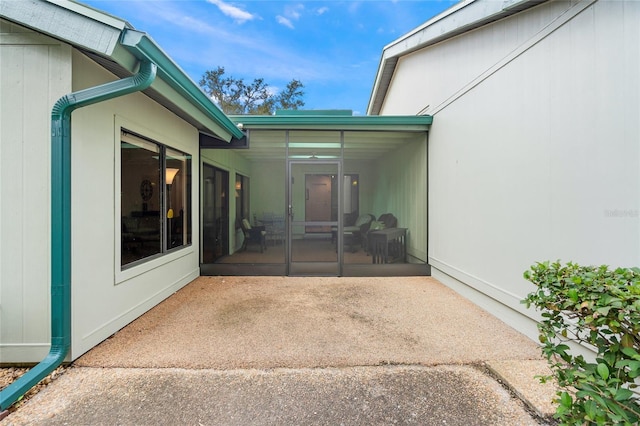 view of patio / terrace featuring a sunroom