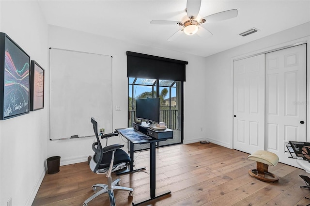 office area with ceiling fan and hardwood / wood-style floors