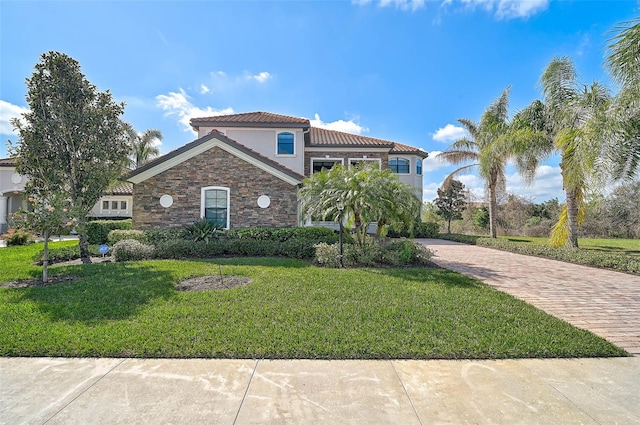 mediterranean / spanish-style house featuring a front yard