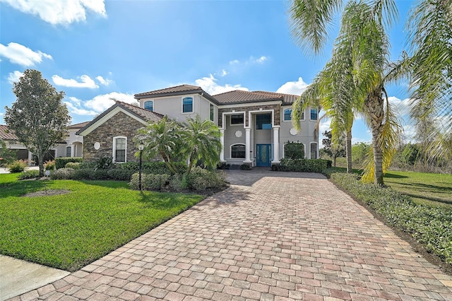 mediterranean / spanish house with a front lawn