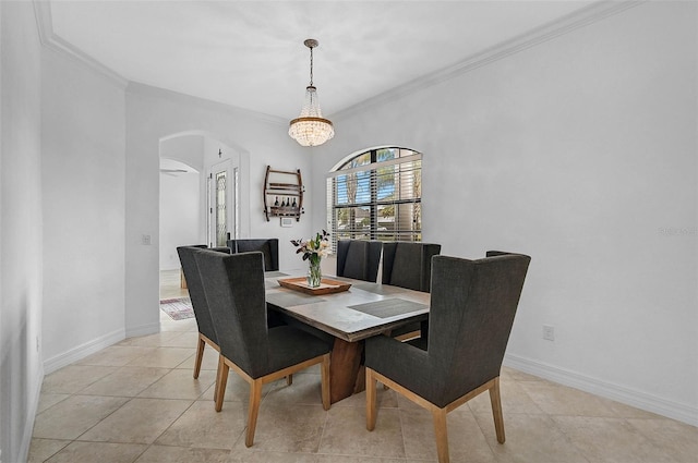 dining space with light tile patterned floors, a notable chandelier, and ornamental molding