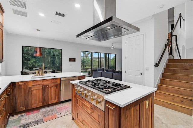 kitchen featuring pendant lighting, sink, appliances with stainless steel finishes, island range hood, and light tile patterned flooring