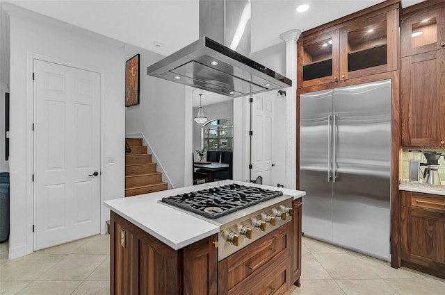 kitchen with light tile patterned flooring, stainless steel appliances, a center island, and island exhaust hood