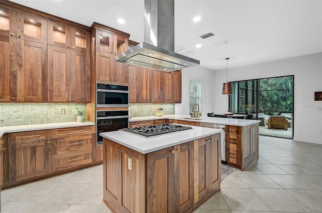 kitchen featuring light tile patterned floors, appliances with stainless steel finishes, hanging light fixtures, a center island, and island exhaust hood