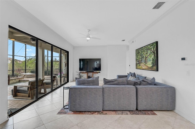 living room with crown molding, ceiling fan, and light tile patterned floors