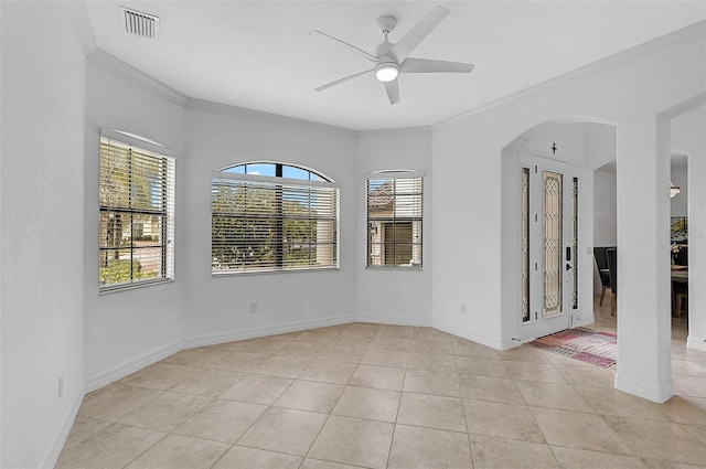 tiled empty room with ornamental molding and ceiling fan