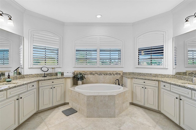 bathroom with tiled tub, ornamental molding, vanity, and tile patterned floors