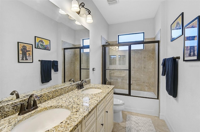 full bathroom with tile patterned floors, vanity, toilet, and combined bath / shower with glass door