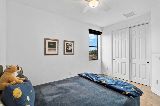 bedroom featuring a closet, ceiling fan, and light hardwood / wood-style flooring