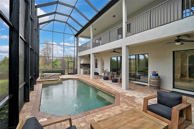 view of pool featuring an in ground hot tub, ceiling fan, exterior kitchen, and a patio