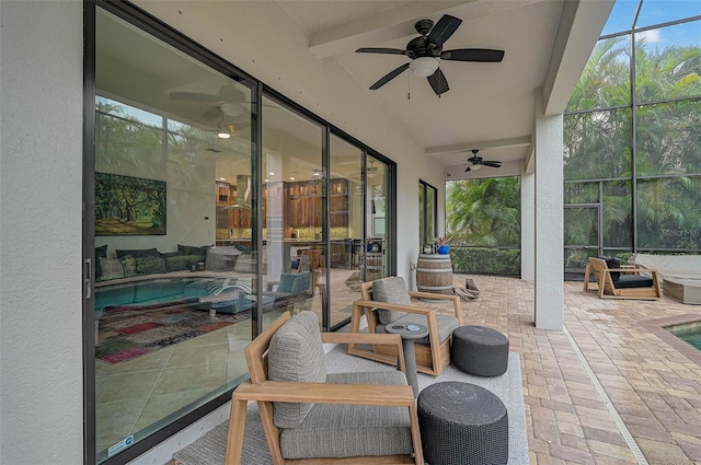 view of patio featuring a lanai and ceiling fan