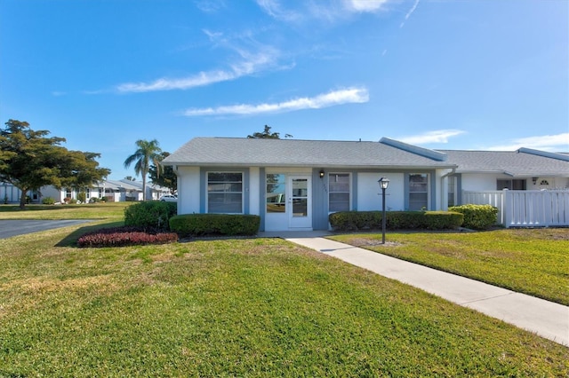 ranch-style house with a front lawn