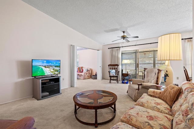 living room featuring ceiling fan, lofted ceiling, light colored carpet, and a textured ceiling