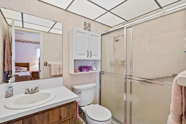 bathroom featuring walk in shower, vanity, and toilet