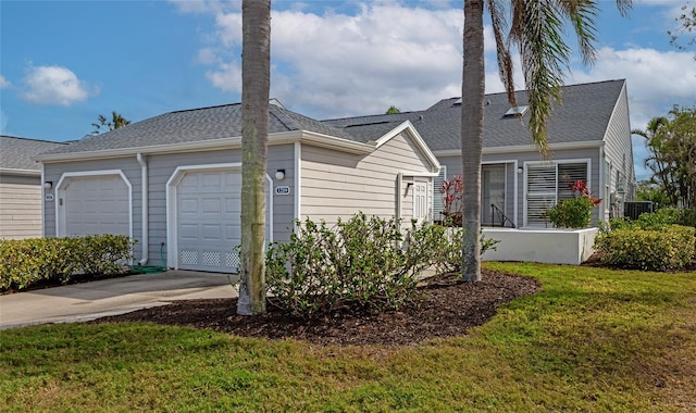 ranch-style house with a garage and a front yard