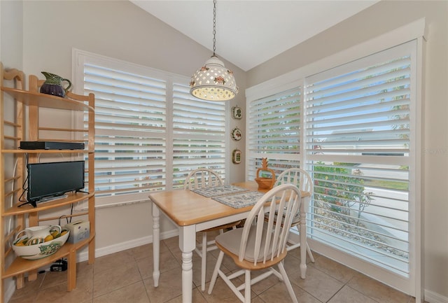 tiled dining area with lofted ceiling