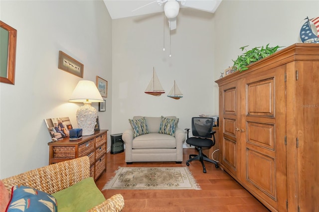 living area featuring light hardwood / wood-style flooring and ceiling fan