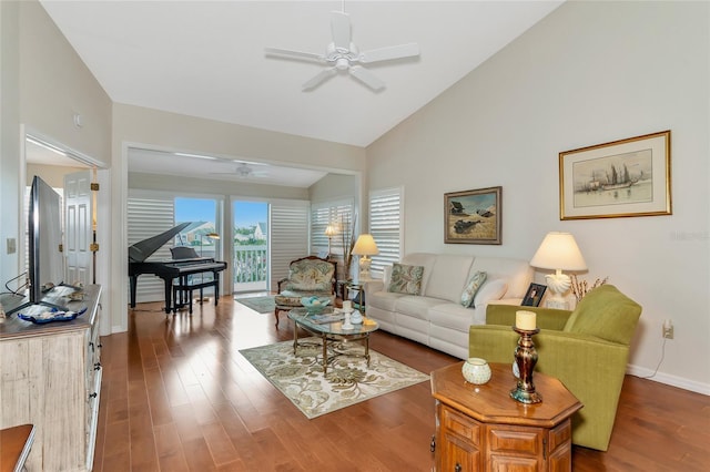 living room with dark wood-type flooring, ceiling fan, and high vaulted ceiling