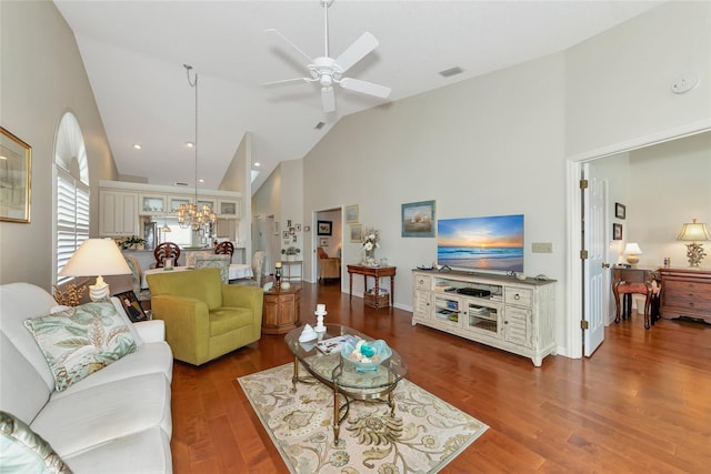 living room featuring ceiling fan with notable chandelier, high vaulted ceiling, and hardwood / wood-style floors