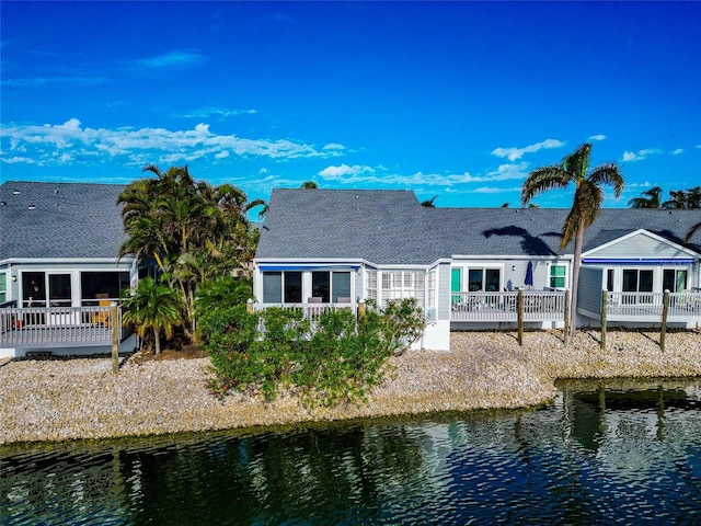 rear view of property with a deck with water view