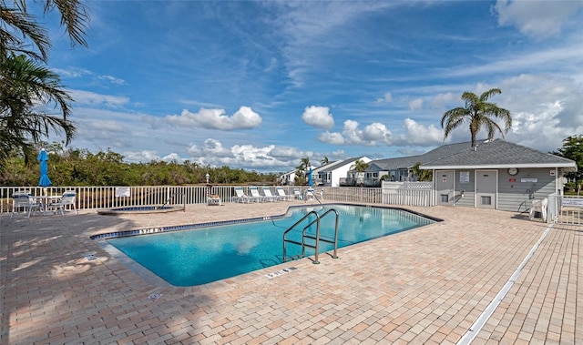 view of pool with a hot tub and a patio area