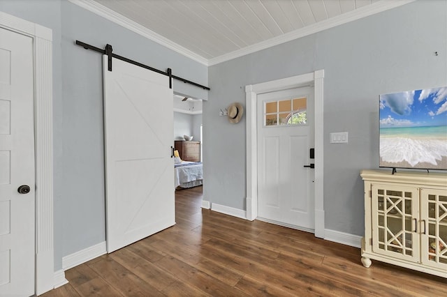 foyer featuring hardwood / wood-style floors, ornamental molding, and a barn door