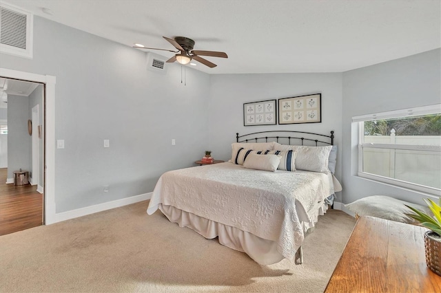 bedroom with vaulted ceiling, ceiling fan, and carpet flooring