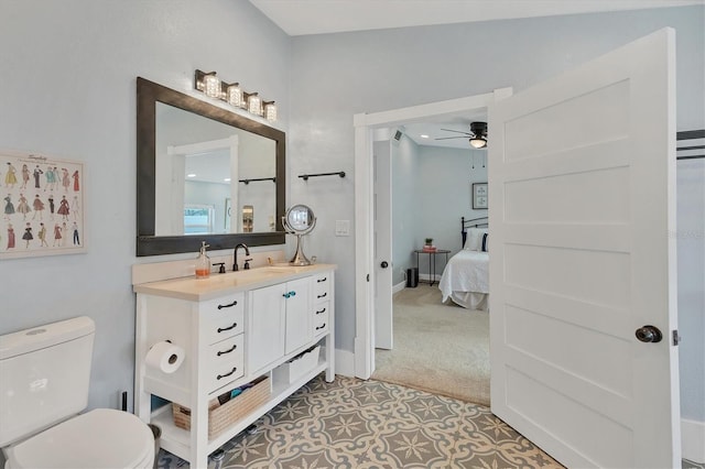 bathroom with vanity, toilet, and ceiling fan