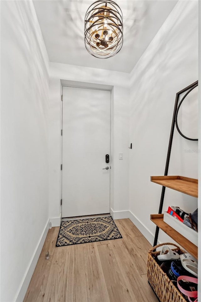 foyer featuring light hardwood / wood-style floors and a notable chandelier