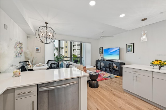 kitchen with ceiling fan with notable chandelier, pendant lighting, stainless steel dishwasher, and light hardwood / wood-style floors