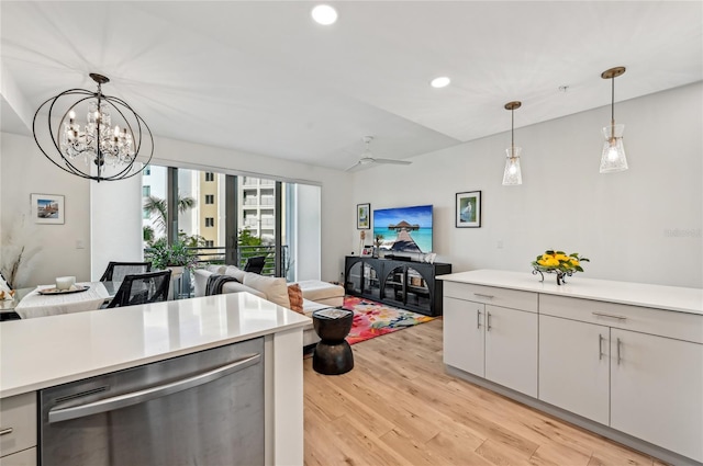 kitchen featuring decorative light fixtures, dishwasher, ceiling fan with notable chandelier, and light wood-type flooring